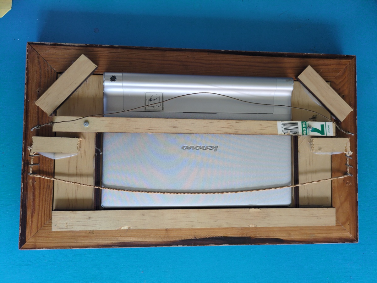 A photo of the rear of the housing with the mounting system for the tablet